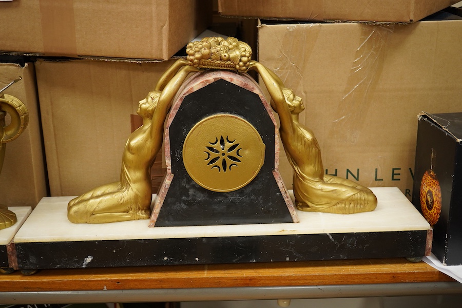A French Art Deco figural and rouge marble clock garniture, 56cm wide. Condition - poor